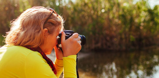 A woman takes pictures outdoors.