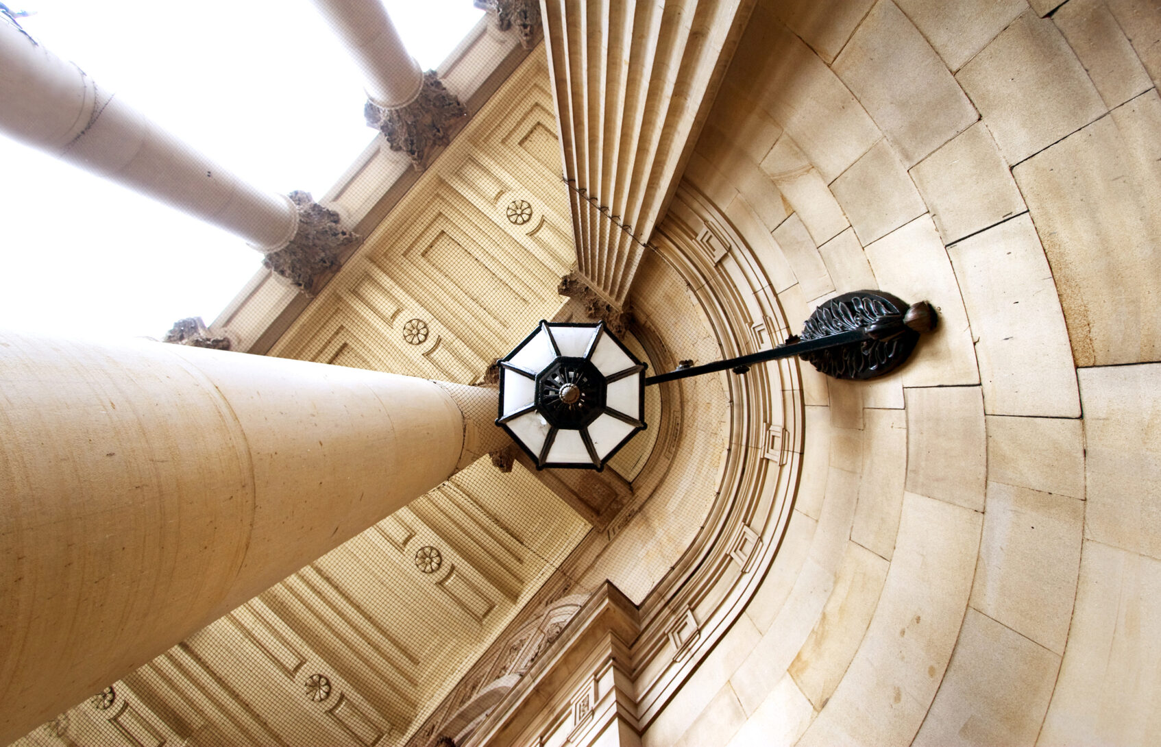 Image of the entrance to the Capitol Building looking up at architectural detail