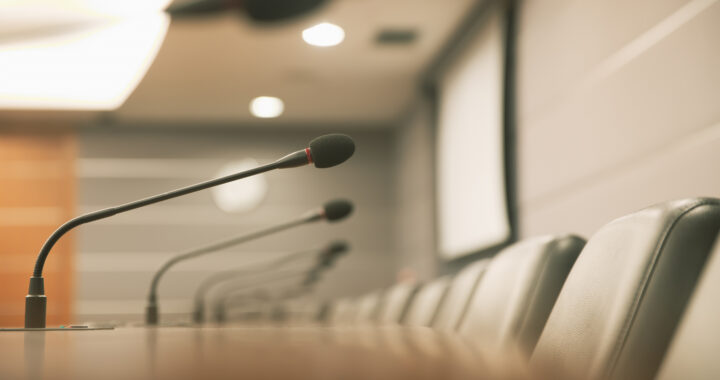 Close up the conference microphone on the meeting table.