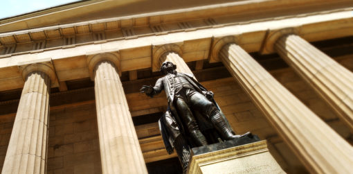 A statue of George Washington stands outside a building
